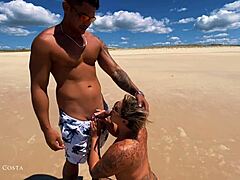 Cassiana Costa gives oral pleasure to a man on a public beach and then engages in doggy-style intercourse with him