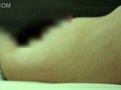 A middle-aged Japanese woman experiences intense pleasure and orgasm during intercourse