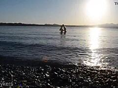 Voyeuristic couple watches lovers engage in intimate beach encounter