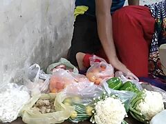 Redheaded Indian girl in sexy clothes sells vegetables to hungry strangers